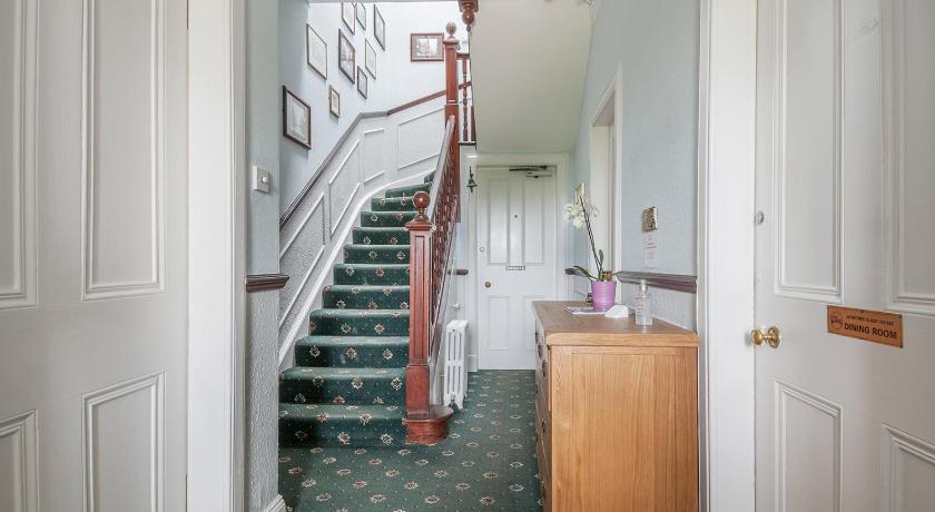 a hallway with stairs leading up to a bedroom, Aynetree Guest House in Edinburgh