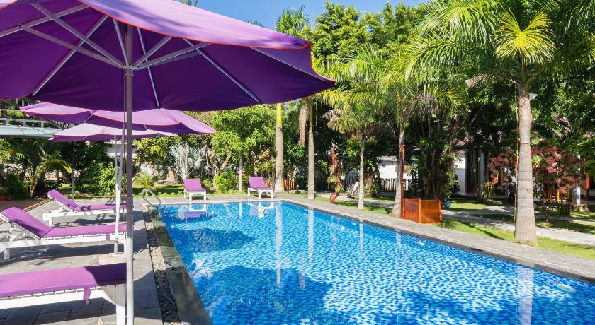 a pool with blue umbrellas on a patio, Hoa Nhat Lan Bungalow in Phu Quoc Island