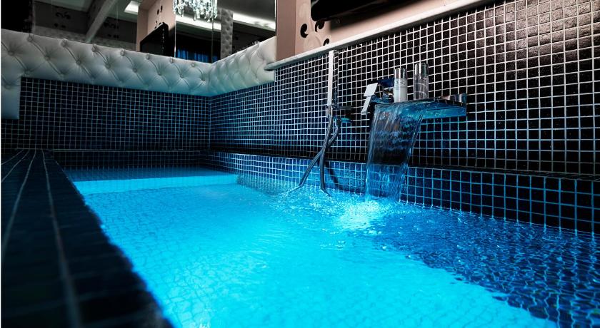 a swimming pool with a person in it, Spagna Royal Suite in Rome