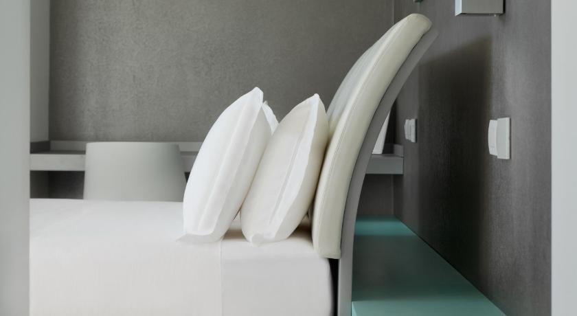 a white bed with white pillows in a room, Life Hotel Seaview & Spa in Porto Recanati
