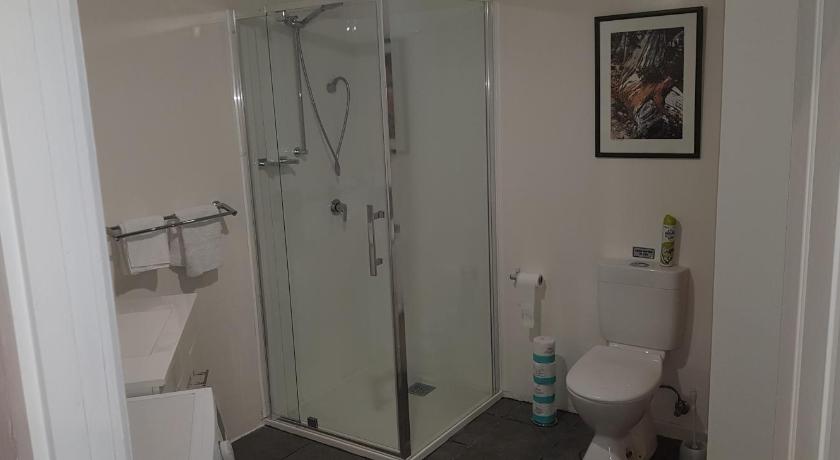 a bathroom with a shower, toilet, and sink, Discover Bruny Island Holiday Accommodation in Bruny Island