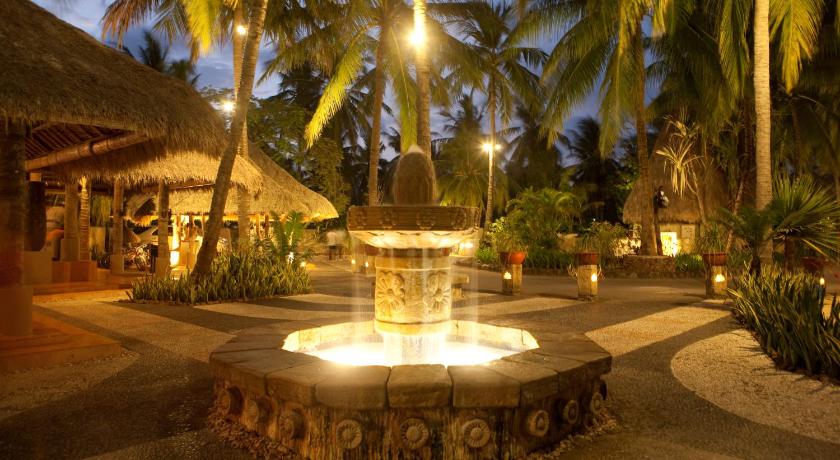 a pool with a fountain and a statue of a man, Novotel Lombok Resort & Villas in Lombok