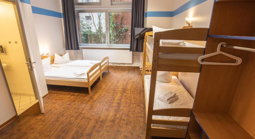 a bedroom with a bed and a desk, acama Hotel + Hostel Kreuzberg in Berlin