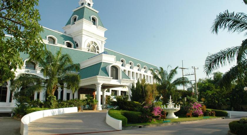 a large white building with a clock tower, Camelot Hotel in Pattaya