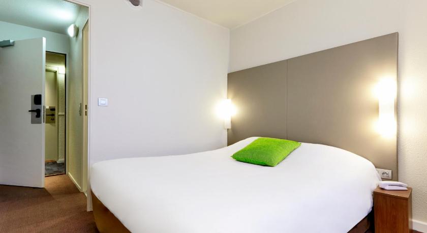 a bedroom with a white bed and white walls, Campanile Paris Est Porte De Bagnolet Hotel in Paris