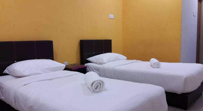 a hotel room with two beds and two lamps, Diamond Hotel in Kota Bharu