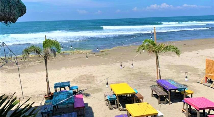 a beach area with chairs, tables and umbrellas, Surfer's Point Deck in La Union