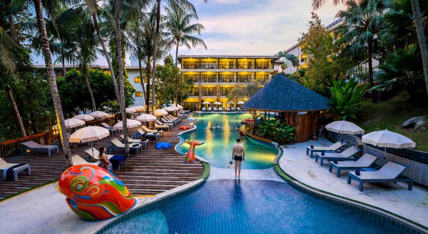 a beach with a pool, chairs, and tables, Peach Hill Resort (SHA Plus+) in Phuket