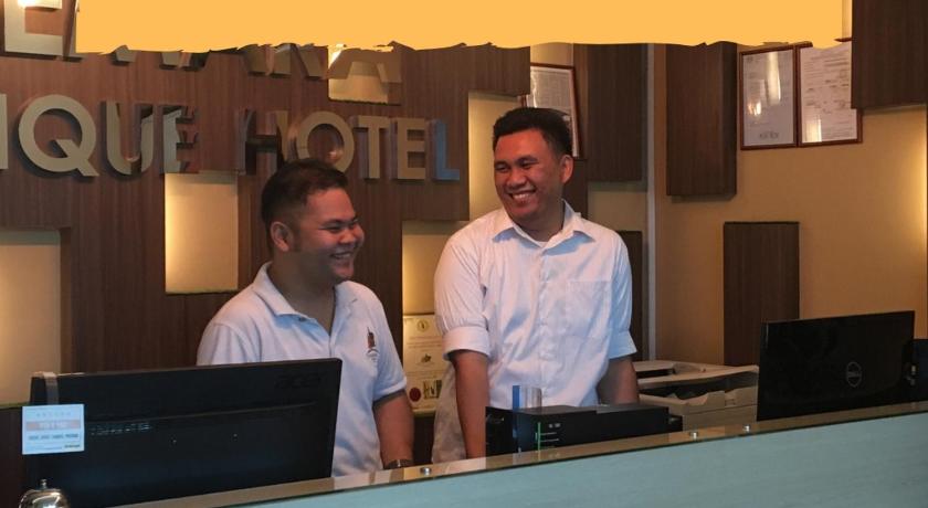 two men standing in front of a laptop computer, Chemara Boutique Hotel in Miri