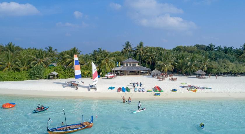 a beach filled with lots of boats and people, Paradise Island Resort and Spa in Maldive Islands