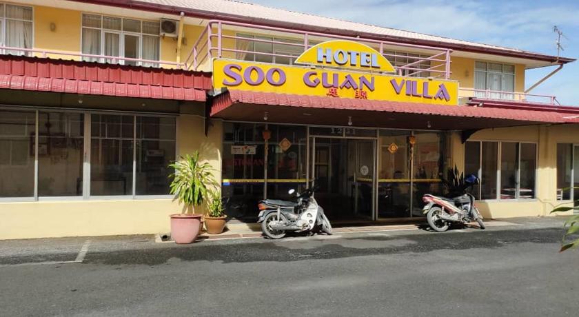 a car parked in front of a store with a motorcycle parked next to it, Soo Guan Villa in Arau