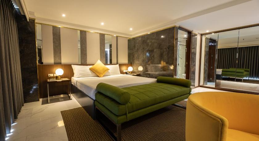 a bedroom with a large bed and a large window, Star Plaza Hotel in Dagupan
