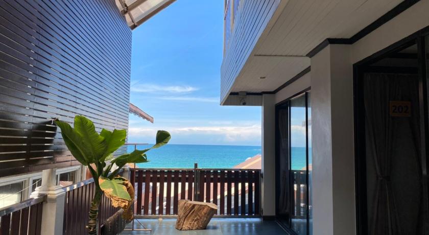 a balcony overlooking a beach with a view of the ocean, Sinsamut Hotel Koh Samed in Ko Samet