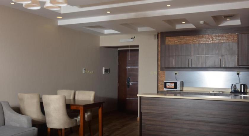 a living room with a kitchen and dining area, Dar Telal Hotel suites in Abha
