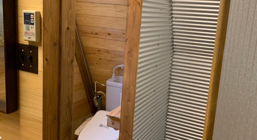 a small bathroom with a toilet and a sink, Guesthouse Coco Garage in Kirishima