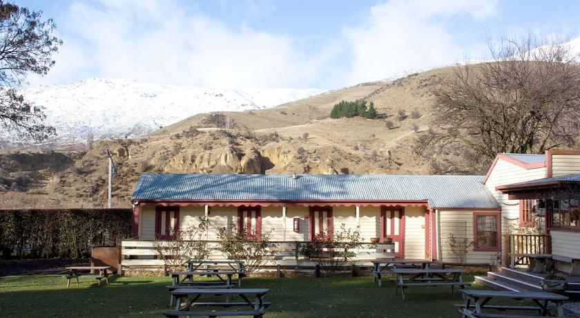 a large building with a bench in front of it, Cardrona Hotel in Queenstown