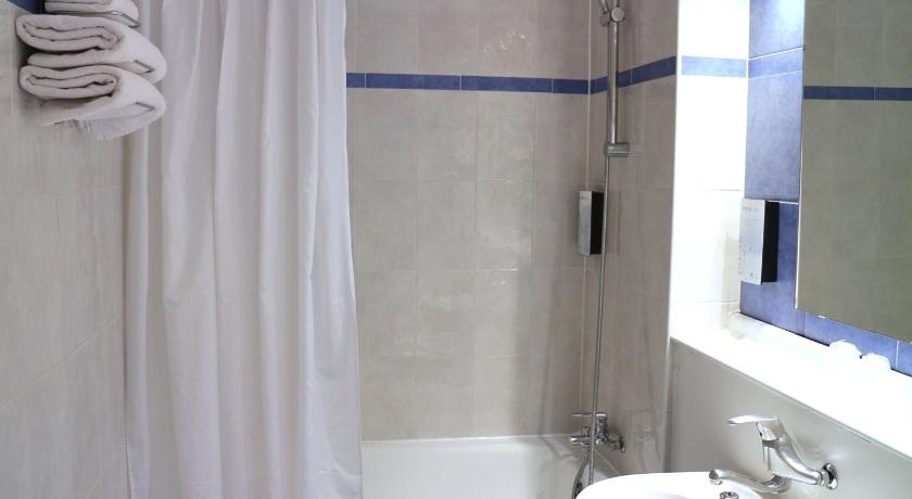 a white bath tub sitting next to a white sink, Hotel Campanile Barcelona - Barbera del Valles in Barbera del Valles