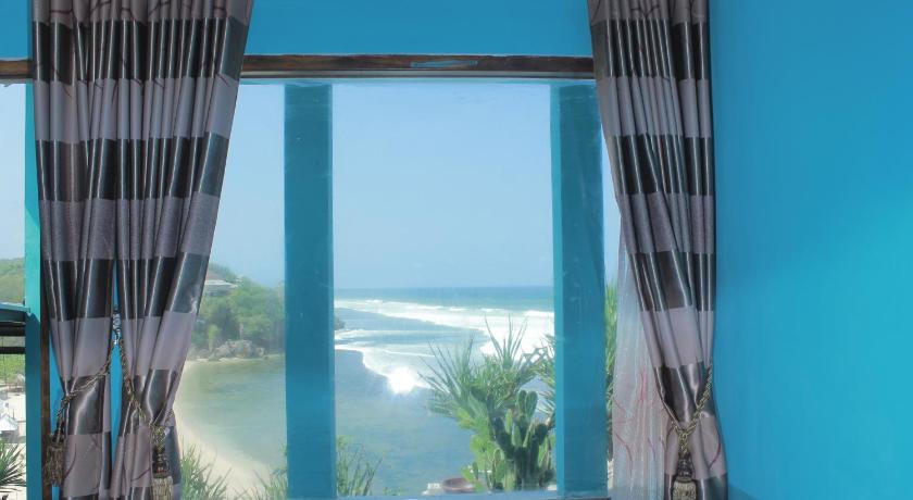 a window with a view of the ocean, Hotel Omah Sundak in Bedoyo