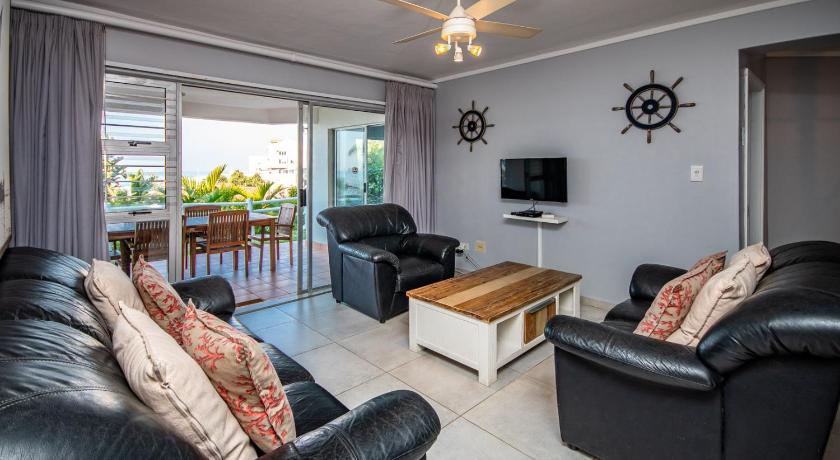 a living room filled with furniture and a tv, Tahiti 11 in Durban