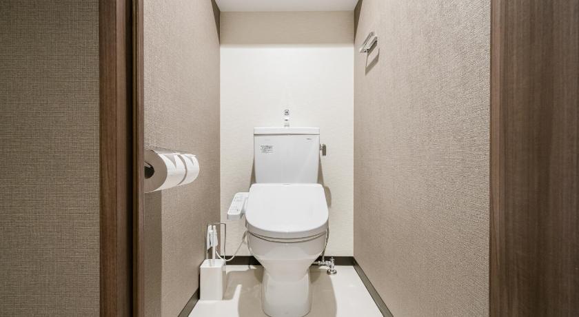a white toilet sitting in a bathroom next to a sink, Bon Condominium Namba Ebisu in Osaka
