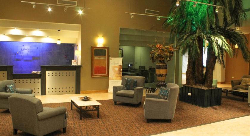 a living room filled with furniture and a tv, Holiday Inn Express Chihuahua in Chihuahua