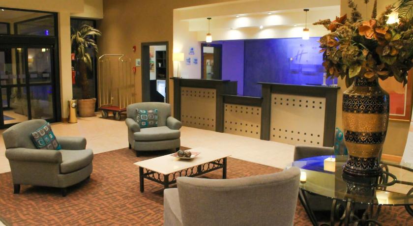a living room filled with furniture and a tv, Holiday Inn Express Chihuahua in Chihuahua