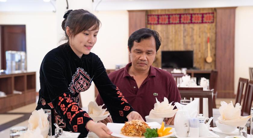 two women sitting at a table with plates of food, Sai Gon - Ba Be in Ba Be