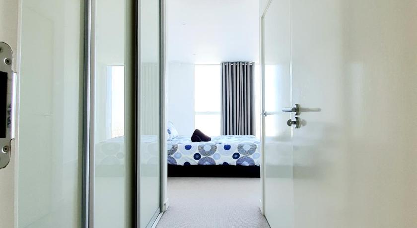 a room with a bed and a mirror, Ultra Modern Room in London