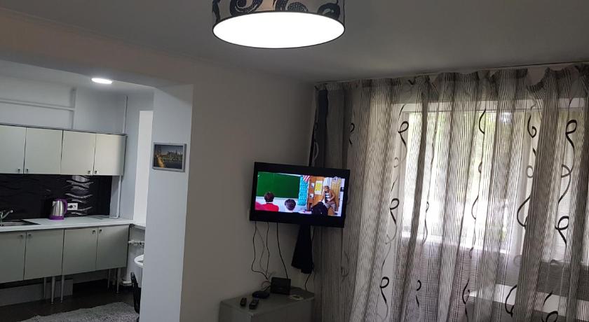 a television is on in the corner of a room, Apartment in Balti in Balti