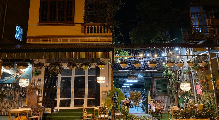 a restaurant with tables, chairs and umbrellas, Cao Bang Eco Homestay in Cao Bang