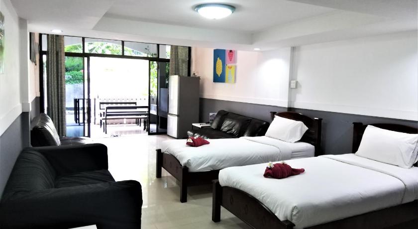 a hotel room with two beds and a television, Blue Moon in Ko Samet
