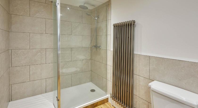 a bathroom with a tub, toilet and shower stall, Host & Stay - Caedmon House in Whitby