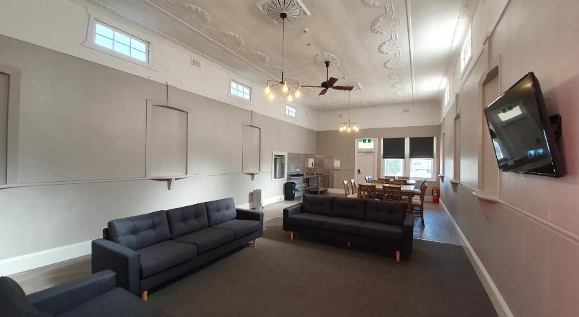 a living room filled with furniture and a tv, The Royal Hotel in Muswellbrook