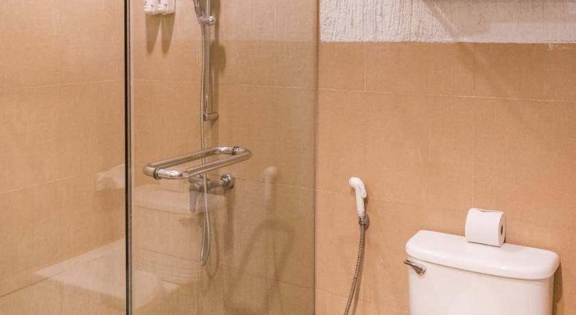 a white toilet sitting next to a shower in a bathroom, Krabi Aquamarine Resort  (SHA Extra Plus) in Krabi