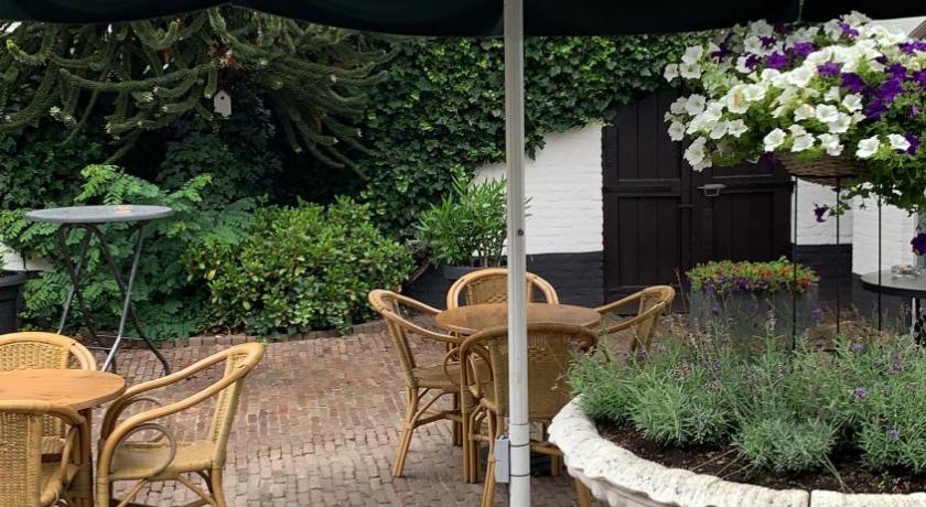 a patio area with a table, chairs, and umbrella, De Witte Hoeve in Venray