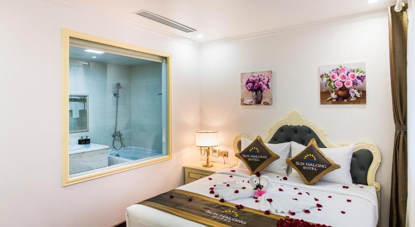 a hotel room with a bed and a mirror, Sun halong hotel in Hạ Long