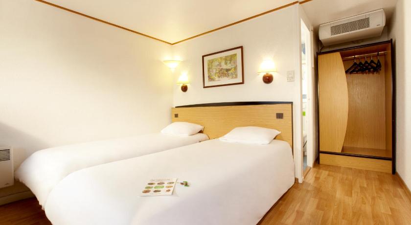 a hotel room with a white bed and white walls, Campanile Paris Ouest - Gennevilliers Port in Paris