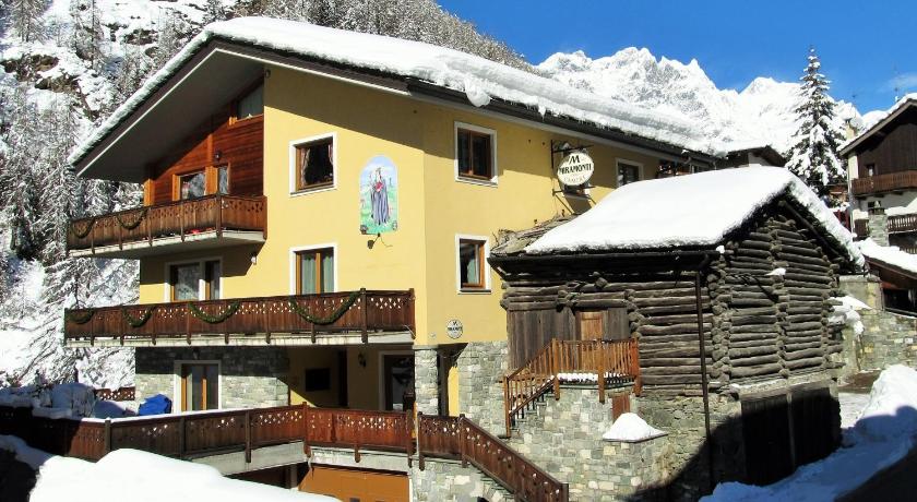 a house with a snow covered roof and some trees, Miramonti Affittacamere Guest House in Valtournenche