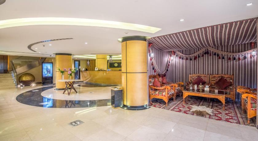 a living room filled with furniture and a large window, Grand Plaza Hotel - Takhasosi Riyadh in Riyadh