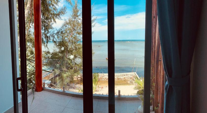 a view from a balcony of a beach with a view of the ocean, Aurora Beach House in Phu Quoc Island