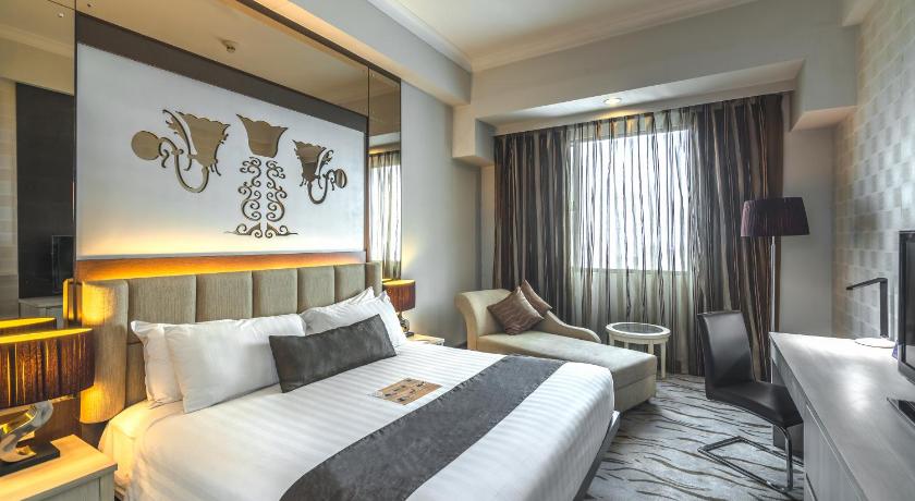 a hotel room with a large bed and a large window, Verwood Hotel and Serviced Residence in Surabaya