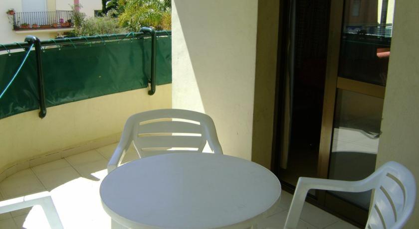 a white chair sitting in front of a patio, Apartamentos Mediterraneo in Nerja