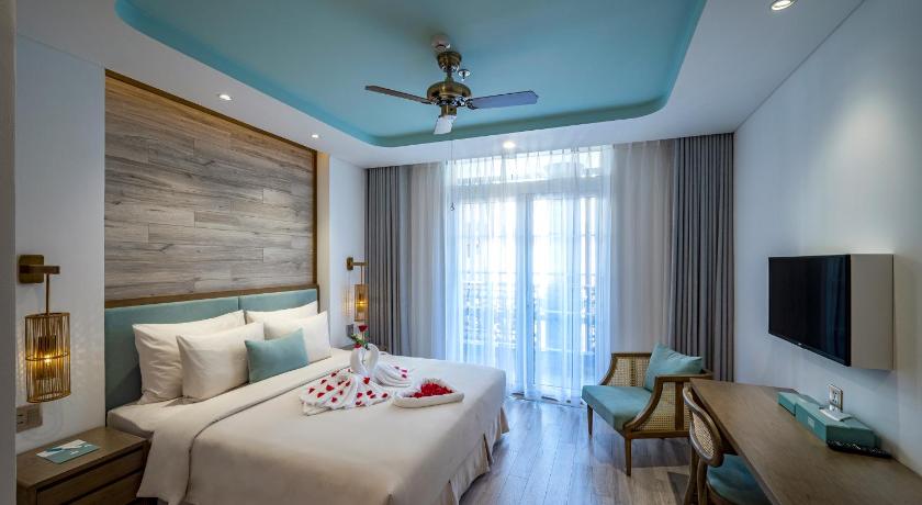 a hotel room with a bed, table and chairs, Icon Saigon - LifeStyle Design Hotel in Ho Chi Minh City