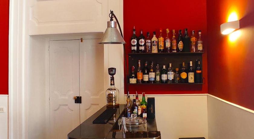 a kitchen with a sink and a shelf with bottles, B&B Palazzo Mirelli in Naples