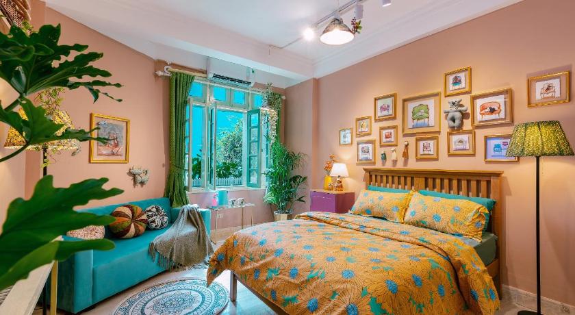 a bedroom with a large bed and a large window, Langmandi Apartment in Hanoi