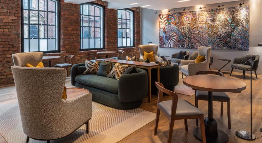 a living room filled with furniture and a large window, The Resident Liverpool in Liverpool