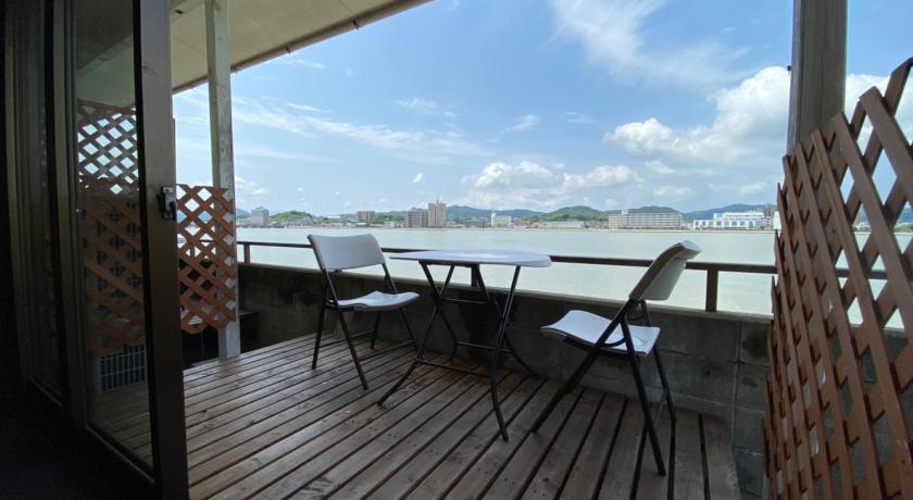a wooden deck with a view of the ocean, Riverside Hotel Karatsu Castle in Karatsu