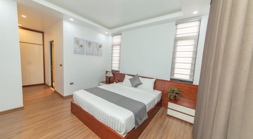 a bedroom with a bed and a dresser, Villa FLC BT 10 - 04 in Hạ Long