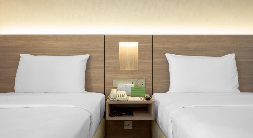 a hotel room with two beds and two lamps, Cititel Hotel Penang in Penang