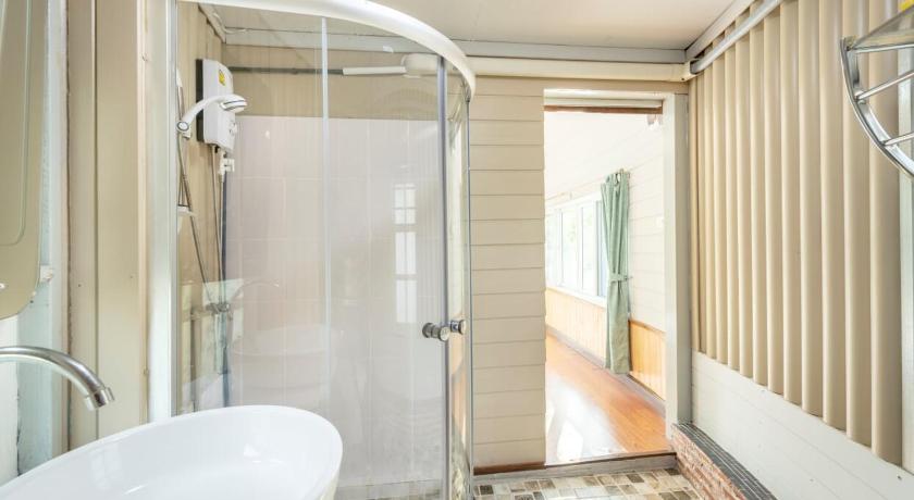 a bathroom with a bath tub, toilet and shower stall, Ratathara Resort in Chachoengsao